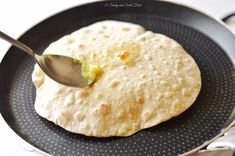 a spoon with some food on it in a pan