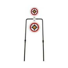 two target stands with arrows on each side and an arrow in the middle, both standing upright