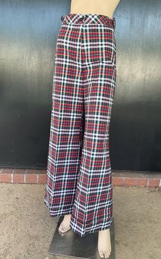 1970s Tomboy of California flare leg pants. White, red and blue cotton. Decorative buckles on sides on waist. Nylon zip front. One button fastener on waistband. Cuffed hems. Size 7 Measurements  26" waist 34" hips 43" length 32" inseam 30" hem sweep each leg Dashing pants show beautifully exhibiting no wear. Deadstock item having never been worn. Retro Plaid Wide-leg Pants, Retro Red Bottoms For Fall, Retro Cotton Wide Leg Full Length Pants, Retro Cotton Wide Leg Pants, Retro Full-length Cotton Pants, Retro Red Cotton Bottoms, Red Retro Full-length Pants, Retro Full-length Red Pants, Red Full Length Retro Pants