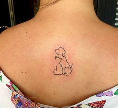 a woman with a dog tattoo on her back