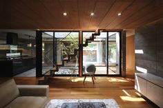 a living room with wooden floors and stairs