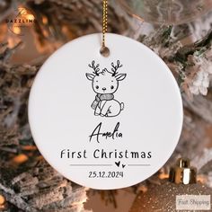 personalized first christmas ornament hanging from a tree