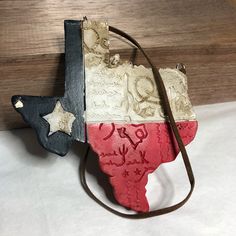 a purse with the shape of texas painted on it