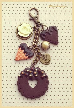 a close up of a key chain on a polka dot background with an ice cream cone