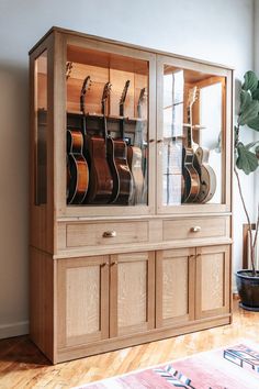 a large wooden cabinet with guitars on it