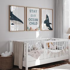 a baby's room with two posters on the wall