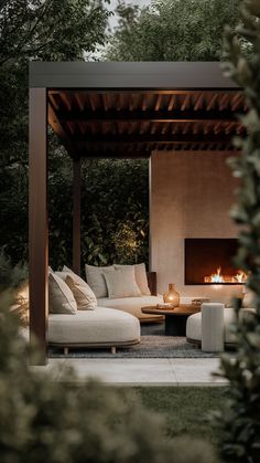 an outdoor living area with couches and fire place