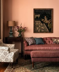 a living room filled with furniture and a painting on the wall