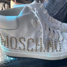 Only Wore Them Once They Are Authentic Moschino High Top Tennis Shoes I Got Them For $1000 But Willing To Let Them Go For $180 Custom High-top Sneakers With Embroidered Logo And White Sole, Gold High-top Custom Sneakers With Boost Midsole, White High-top Sneakers With Logo Patch, High Top Tennis Shoes, Moschino Shoes, Love Moschino Sneakers, Moschino Accessories, Tennis Shoes, Womens Shoes Sneakers