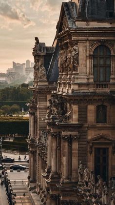 an old building with many statues on the front and side of it in paris, france