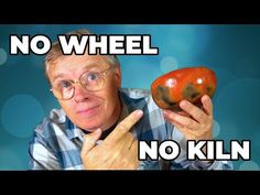 a man holding an orange in front of his face with the words no wheel on it