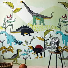 a wall with dinosaurs and plants painted on it in a room that has a basketball hoop