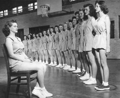 an old black and white photo of women in uniforms