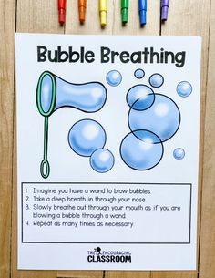 the bubble breathing activity is displayed on a wooden surface with crayons around it