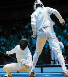 two men in white fencing suits are on the ground