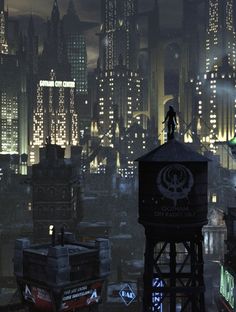 a man standing on top of a tower in the middle of a city at night