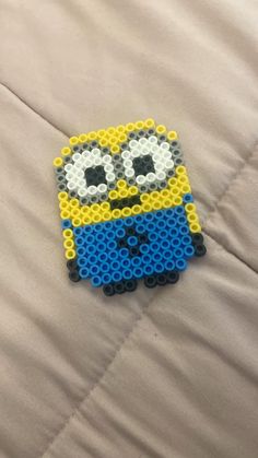 a lego minion is sitting on top of a bed