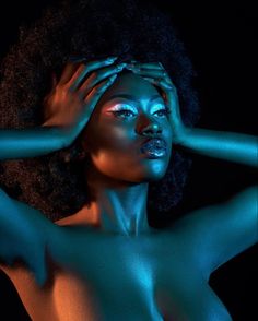 an image of a naked woman with blue light on her face and hands behind her head