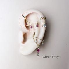 a pair of ear piercings sitting on top of a white piece of jewelry next to each other