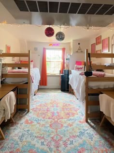 a room with bunk beds and colorful rugs