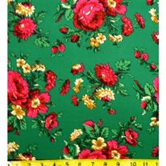 a green background with red and yellow flowers on it, next to a measuring tape