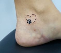 a small dog paw with a heart tattoo on it's side foot, which has a paw print in the shape of a heart