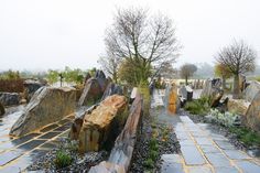 an old cemetery with large rocks and trees