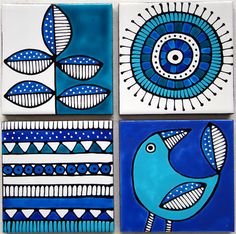 three blue and white tiles with birds on them