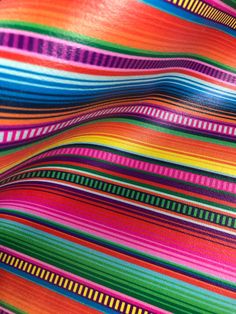 multicolored striped fabric is shown in close up view with no background or pattern