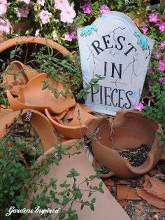 there are many potted plants in front of a sign that says rest in pieces