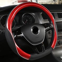 the steering wheel cover is red and black with white stitchs on it's sides