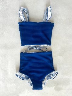 This darling tankini is basically four swimsuits in one (see the variations below). In our opinion, it is as cute as swimsuits come. We tested the fabrics in the salty ocean, sandy beaches, pools, and hot-tubs. It is high-quality, comfortable, and SO much fun!! Truly, a combination you won't want to live (or swim) without ;). Mid-waisted reversible bottoms Leg ruffle on size 6 only (picture below) Adjustable top with tie-string back High-quality textured fabric with cutest seashell print Full Co Clothes Preppy, Floral Swimwear, Swimming Suits, Reversible Top, Preppy Clothes, Coordinating Outfits, Embroidered Shoes, Cute Bathing Suits