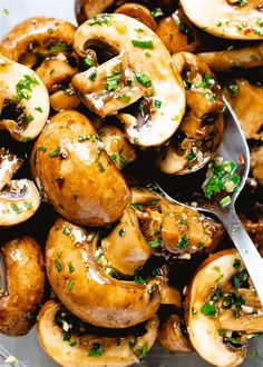 cooked mushrooms with parsley on top in a white serving dish, ready to be eaten