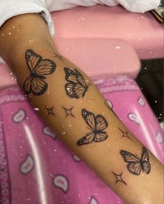 a woman's arm with butterflies on it