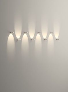 a group of lights that are next to each other on a wall in a room