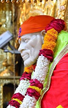 the statue is decorated with flowers and garlands