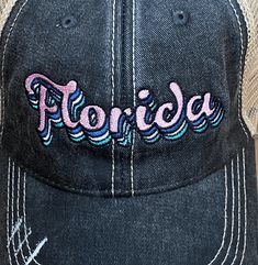 Florida Pastel Layered Embroidered Distressed Baseball Cap / Trucker Hat - Black trucker caps are embroidered and have curved bill distressed cap gives it a worn look adjustable tab with mesh back 65% cotton and 35% polyester one size fits most Designed by Katydid Black Embroidered Trucker Hat, Vintage Black Trucker Hat For Spring, Spring Distressed Snapback Baseball Cap, Distressed Snapback Baseball Cap For Spring, Black Distressed Snapback Trucker Hat, Adjustable Embroidered Trucker Baseball Cap, Distressed Trucker Hat With Curved Brim, Distressed Snapback Trucker Hat For Spring, Adjustable Trucker Baseball Cap With Embroidery