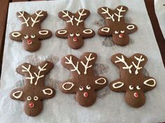 decorated cookies with reindeer faces and noses on a paper towel, ready to be eaten