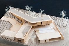 an architectural model of a house on the water's edge