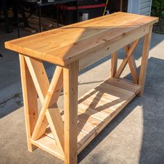 a wooden table sitting on top of a sidewalk