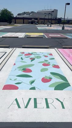 an empty parking lot that has been painted with different colors and designs on the pavement