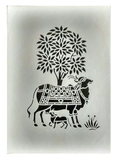 an intricately designed stencil depicting a cow and tree