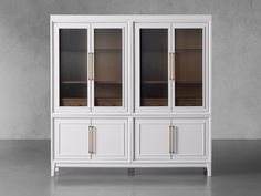 a white china cabinet with glass doors on the top and bottom, in front of a gray wall