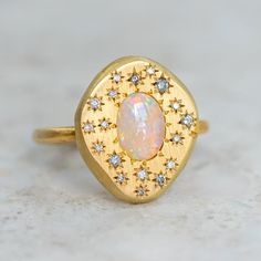 Our pebble collection of raw, rough, beaten metals set with precious gems. Perfectly imperfect and all one of a kind. A magical crystal opal from Coober Pedy is surrounded by star set salt and pepper diamonds. Opal measures approx. 7 x 5mm. Pebble measures approx. 17.5 x 15mm. Band width approx. 1.8mm. Gold weight approx. 5.8g in 14ct, 6.6g in 18ct. Pictured with a matte finish. For a high shine finish on the band, please leave a note at checkout. Please note, we will match the opal as close to the image as possible. Each opal is unique and may vary in appearance and colour from what is depicted on the site. Magical Crystal, Pebble Ring, The Bling Ring, Coober Pedy, Jewellery Inspiration, Crystal Opal, Salt And Pepper Diamond, Precious Gems, Opal Crystal