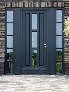 a black front door on a brick building