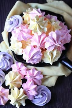 there are many different types of cupcakes in the pan on top of each other