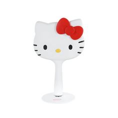 a white hello kitty wine glass with a red bow on it's head is shown