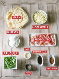 the ingredients to make an appetizer laid out on a wooden table, including meats and cheeses