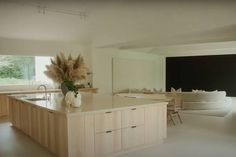 a large kitchen with an island in the middle