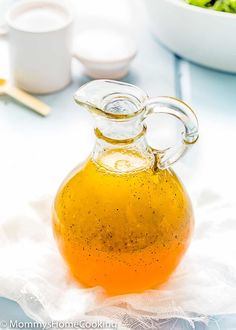 a glass jug filled with liquid sitting on top of a table